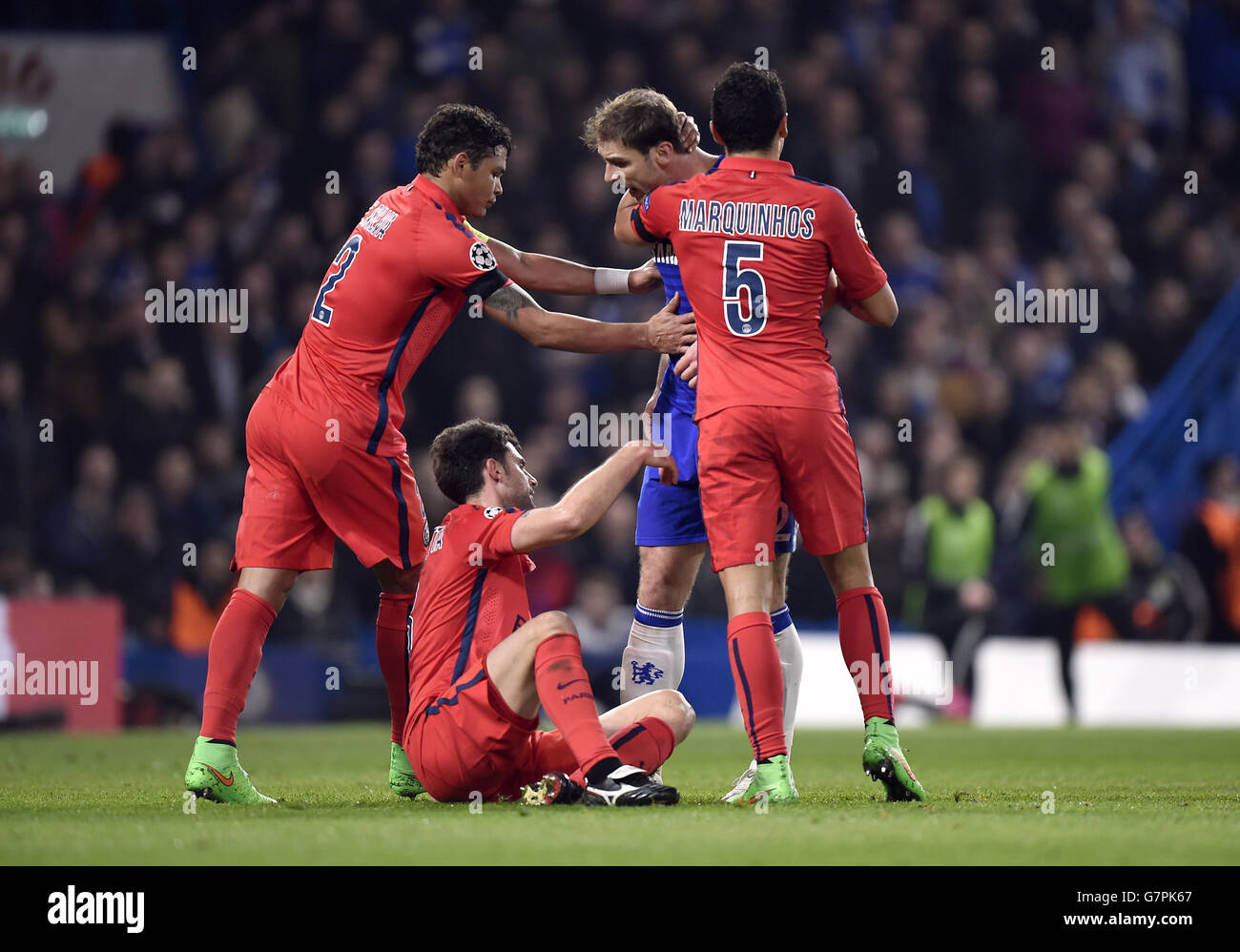 Chelsea's Branislav Ivanovic is held back from Paris St Germain's Thiago Motta by his team-mates Thiago Silva (left) and Marquinhos during the UEFA Champions League Round of Sixteen match at Stamford Bridge, London. Stock Photo