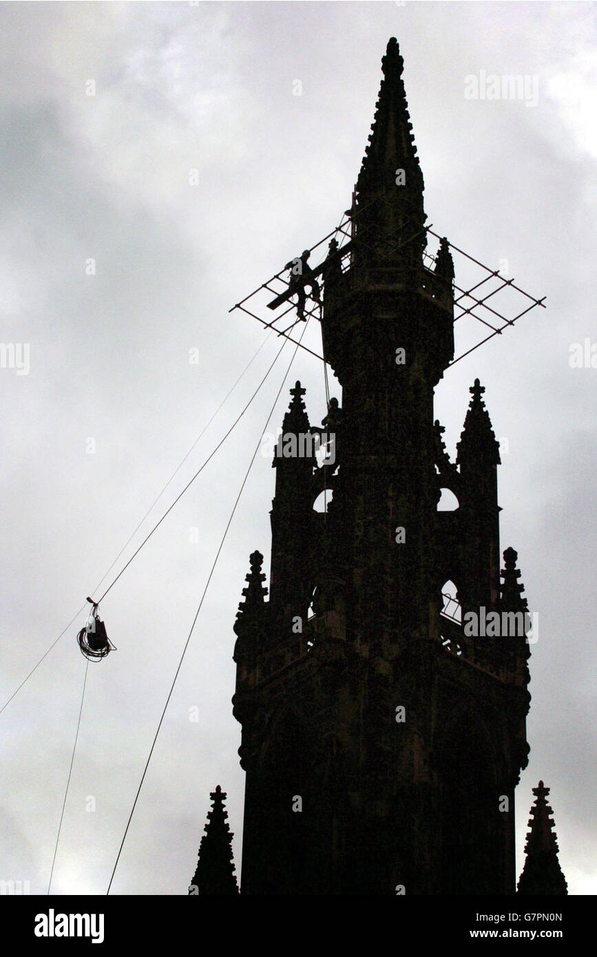 Workmen hang from the top of the Scott Monument in Edinburgh, as work ...