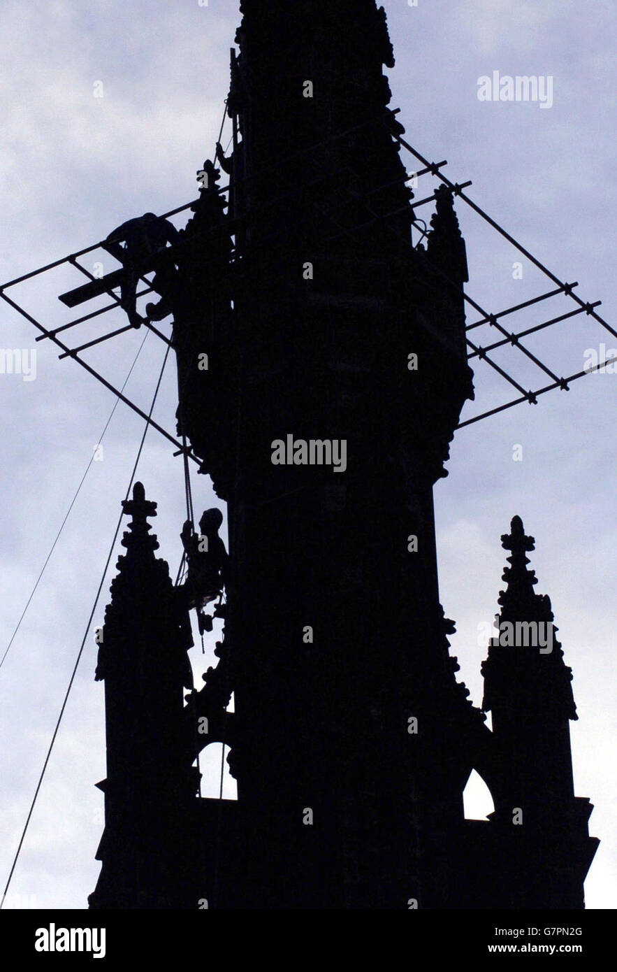 Workmen hang from the top of the Scott Monument in Edinburgh, as work ...