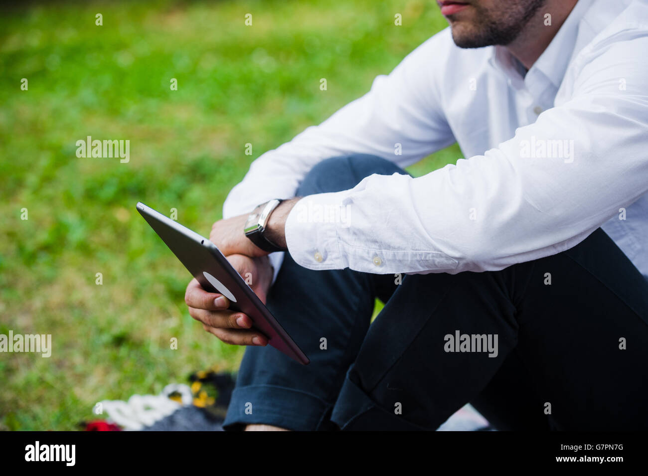 Businessman Using Tablet Computer in park. Close-up shot. Stock Photo