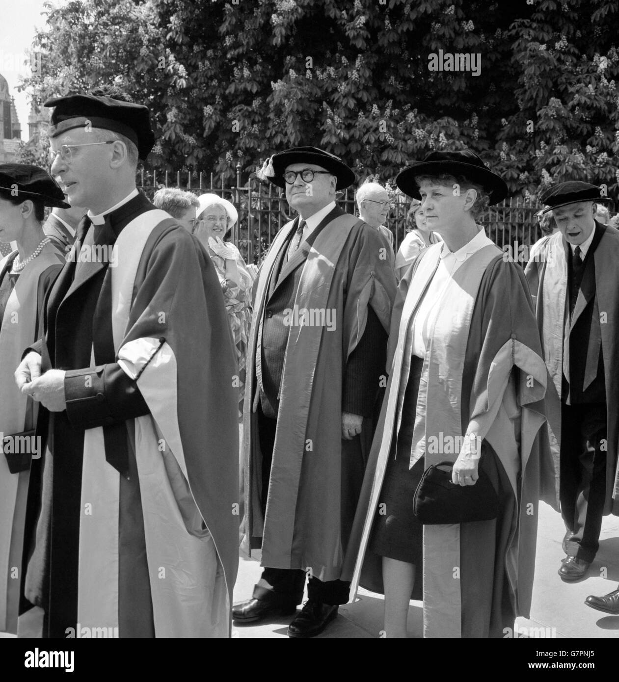 Francois Louis Ganshof, Emeritus Professor of Medieval History in the University of Ghent, Belgium, walking in procession with Dame Evelyn Adelaide Sharp at Cambridge when they received honorary degrees at the University. The Belgian University professor received an honorary doctorate of letters and Dame Evelyn received an honorary doctorate of law. The conferment was held in Cambridge University's Senate House. Stock Photo
