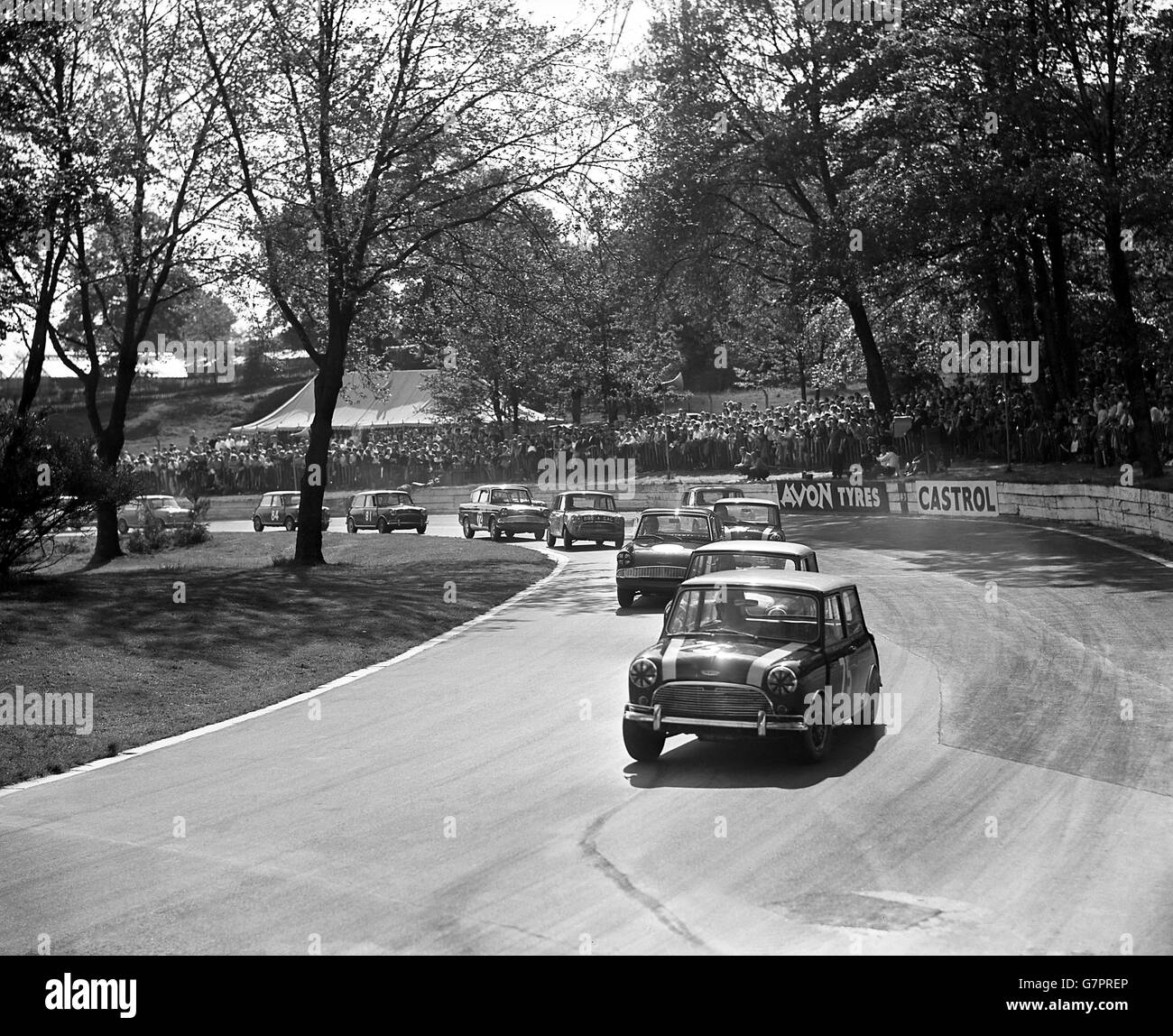 A mini cooper leads the field at the North Tower Crescent bend during the small car trophy race. Stock Photo