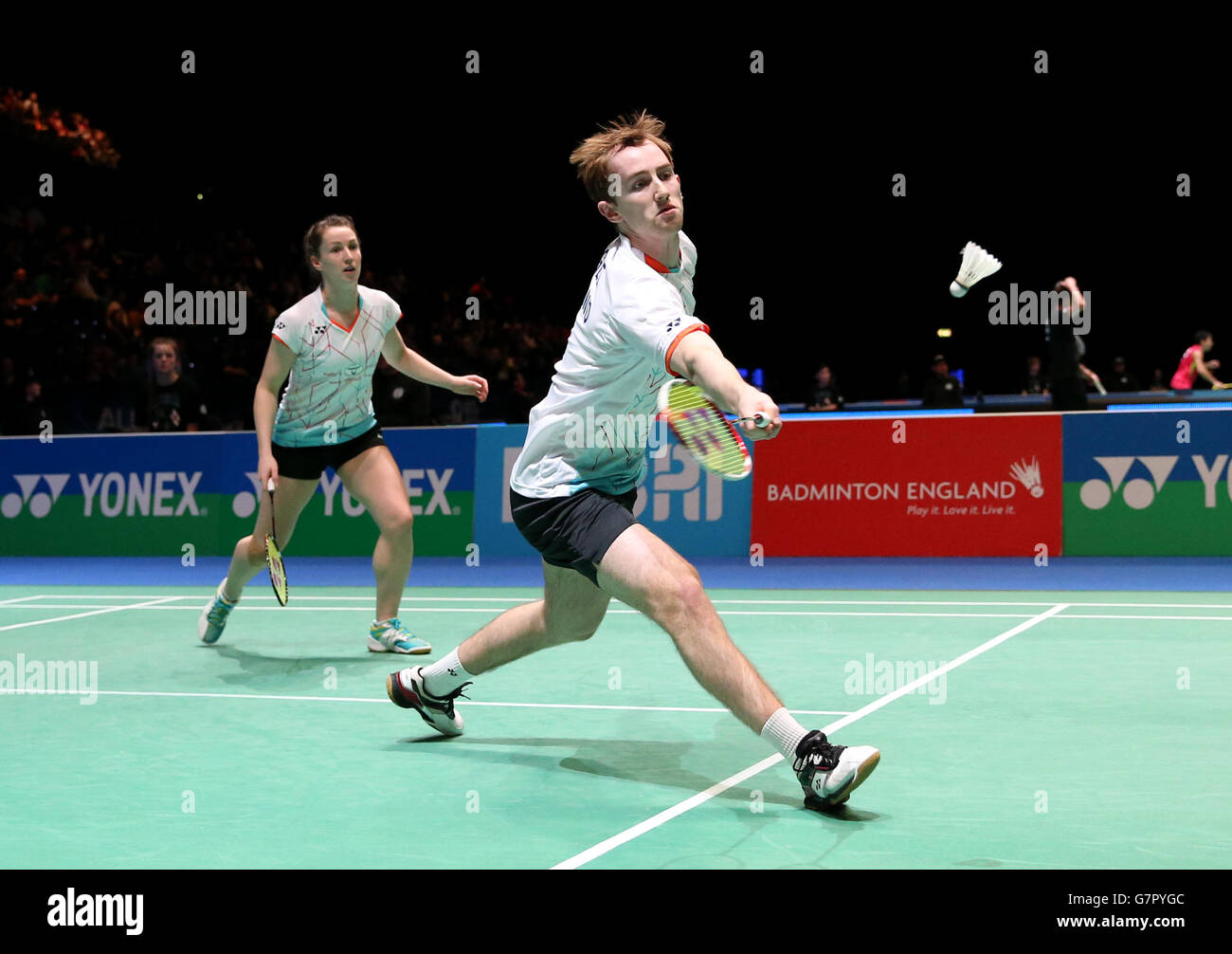 Badminton - 2015 Yonex All England Badminton Championships - Day One - National Indoor Arena. Ireland's Sam Magee during his first round doubles match with partner Chloe Magee (left) Stock Photo