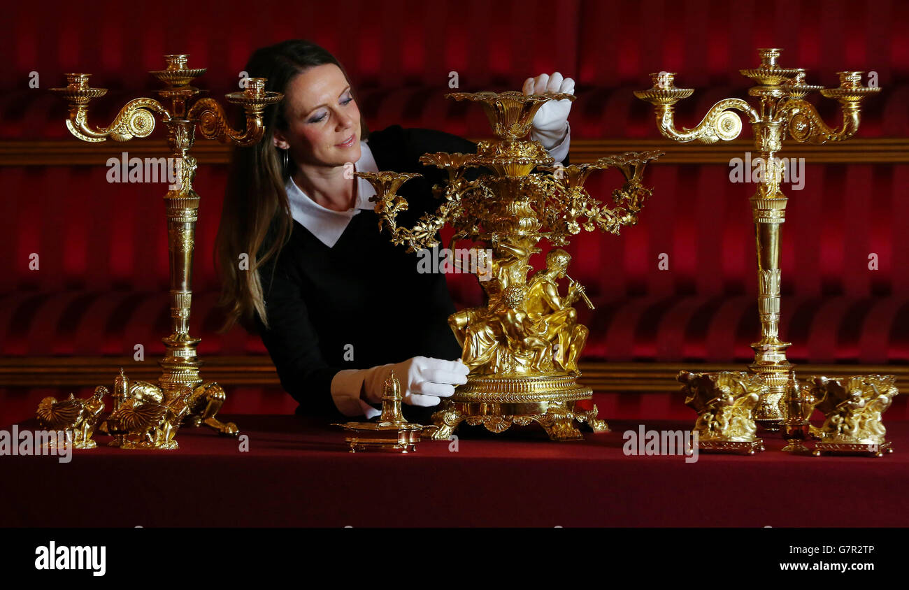 Anna Reynolds, curator of the forthcoming exibition 'A Royal Welcome' prepares a silver-gilt centrepiece used by George IV, which is amongst items used at State Banquets, and is included in displays during the summer opening of Buckingham Palace. Stock Photo