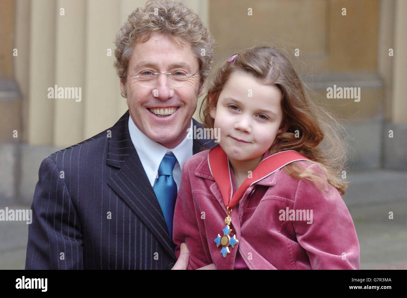 Roger Daltrey from the The Who poses with his grand-daughter Lily, 6. The singer had just been honoured as a Commander of the British Empire (CBE) for services to music. Stock Photo