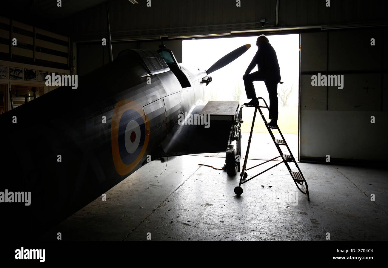Previously unissued photo dated 18/03/15 of Tony Eitheridge from Hawker Restorations Ltd next to a Hawker Hurricane Mk 1 in his Suffolk workshop, as the plane which was shot down in September 1940, is undergoing a full restoration to coincide with the 75th anniversary of the Battle of Britain this year. Stock Photo