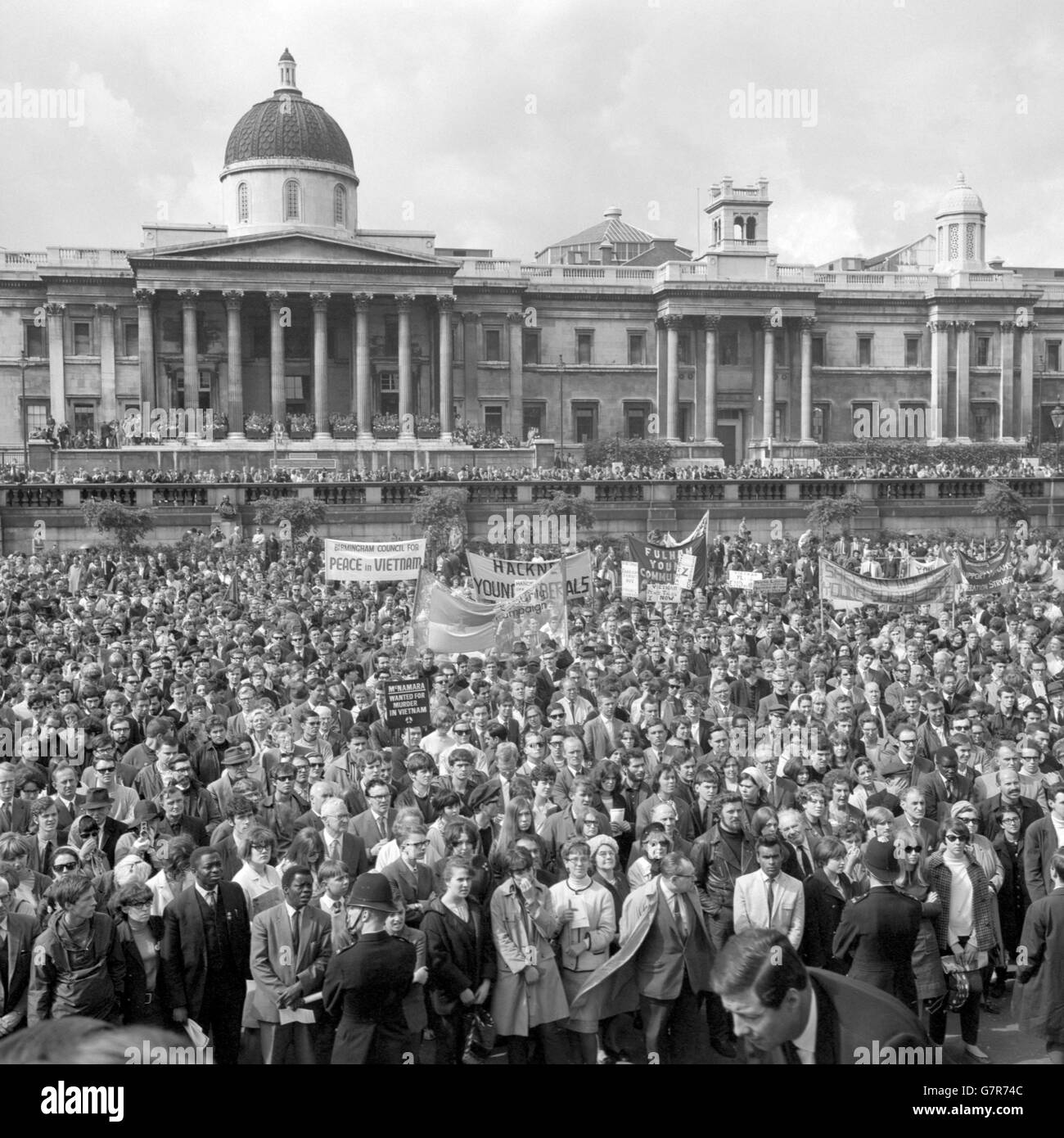 Banners are raised in the sunday sunshine in Trafalgar Square, London, during the protest meeting against the war in Vietnam. The rally was organised by the Campaign for Nuclear Disarmament and called for the dissociation of Britain from American actions in Vietnam. Stock Photo