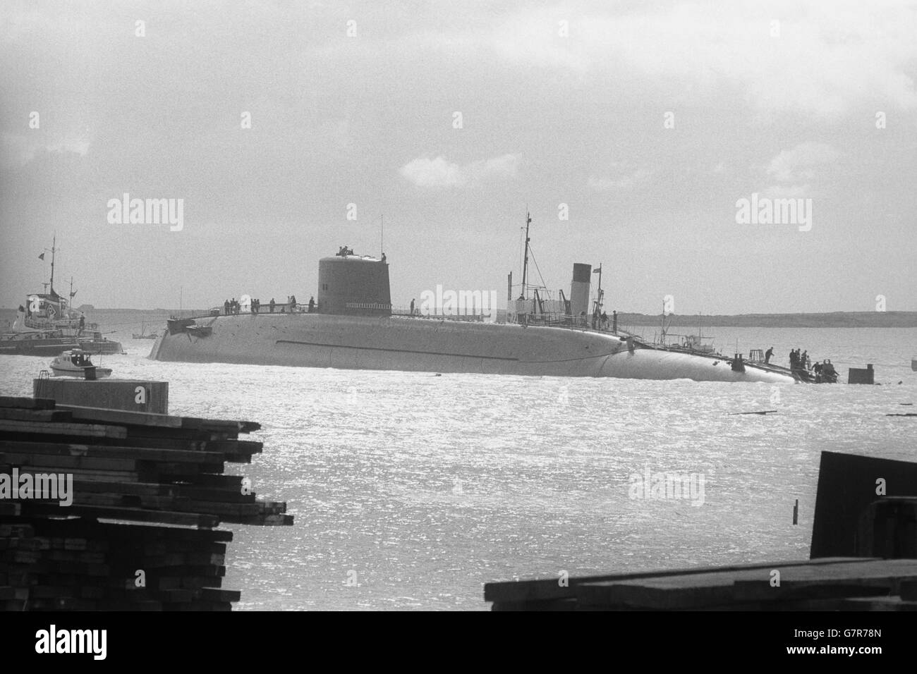 HMS Resolution, Britain's first Polaris submarine, in the water at Barrow in Furness, after being named by the Queen Mother. Protestors against Britain's Polaris programme stood with placards on the approach road as the Queen Mother arrived at Vickers Armstrong Shipyard for the naming and launching ceremony. HMS Resolution, about 7,000 tons, is one of four Polaris submarines which should be operational by 1970. Stock Photo