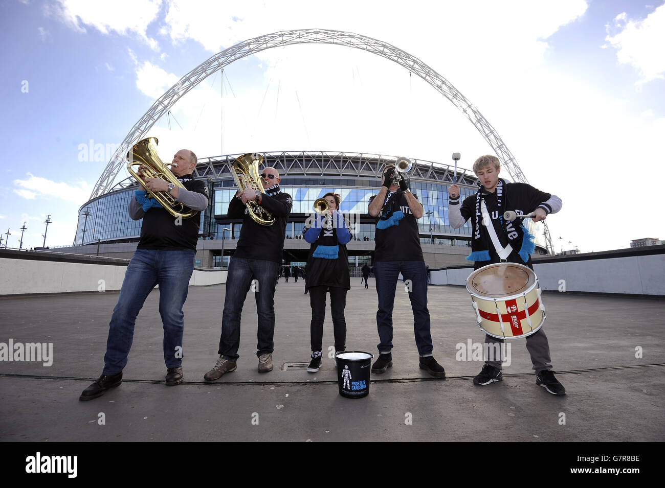 The England Supporters band playing as the Men United band perform next to the Bobby Moore statue at Wembley in aid of Prostate Cancer UK Stock Photo