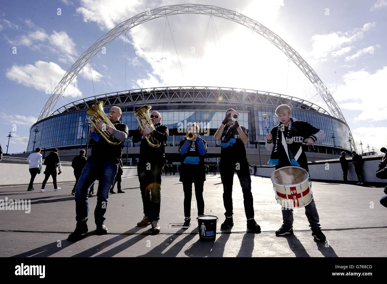 The England Supporters band playing as the Men United band perform next to the Bobby Moore statue at Wembley in aid of Prostate Cancer UK Stock Photo