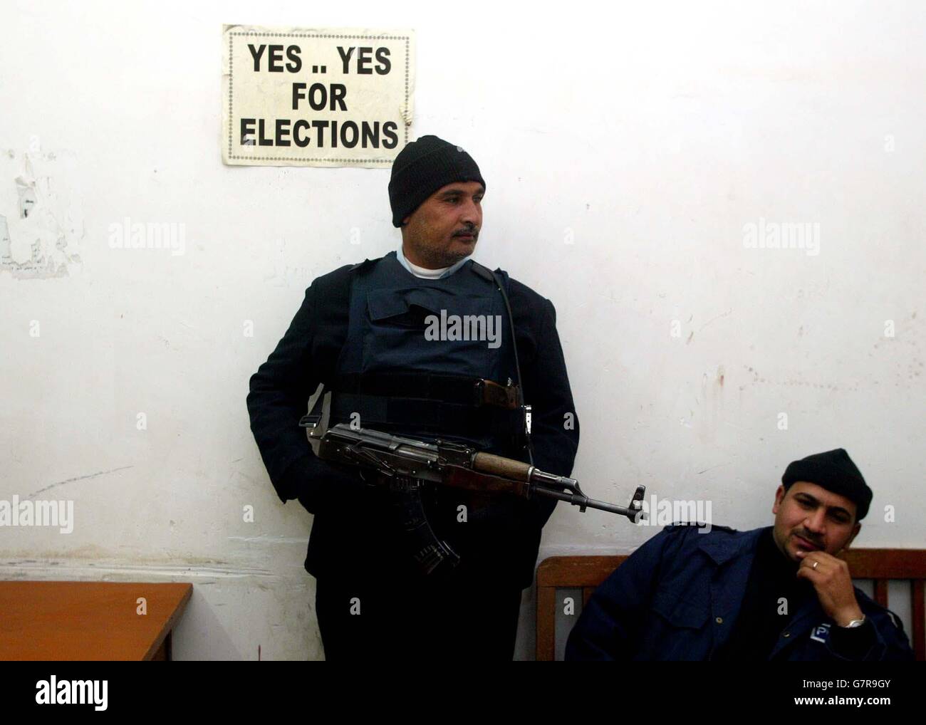 Iraq police officers at the Central Police Station, guard the entrance to the station as security tightens for the elections. Stock Photo