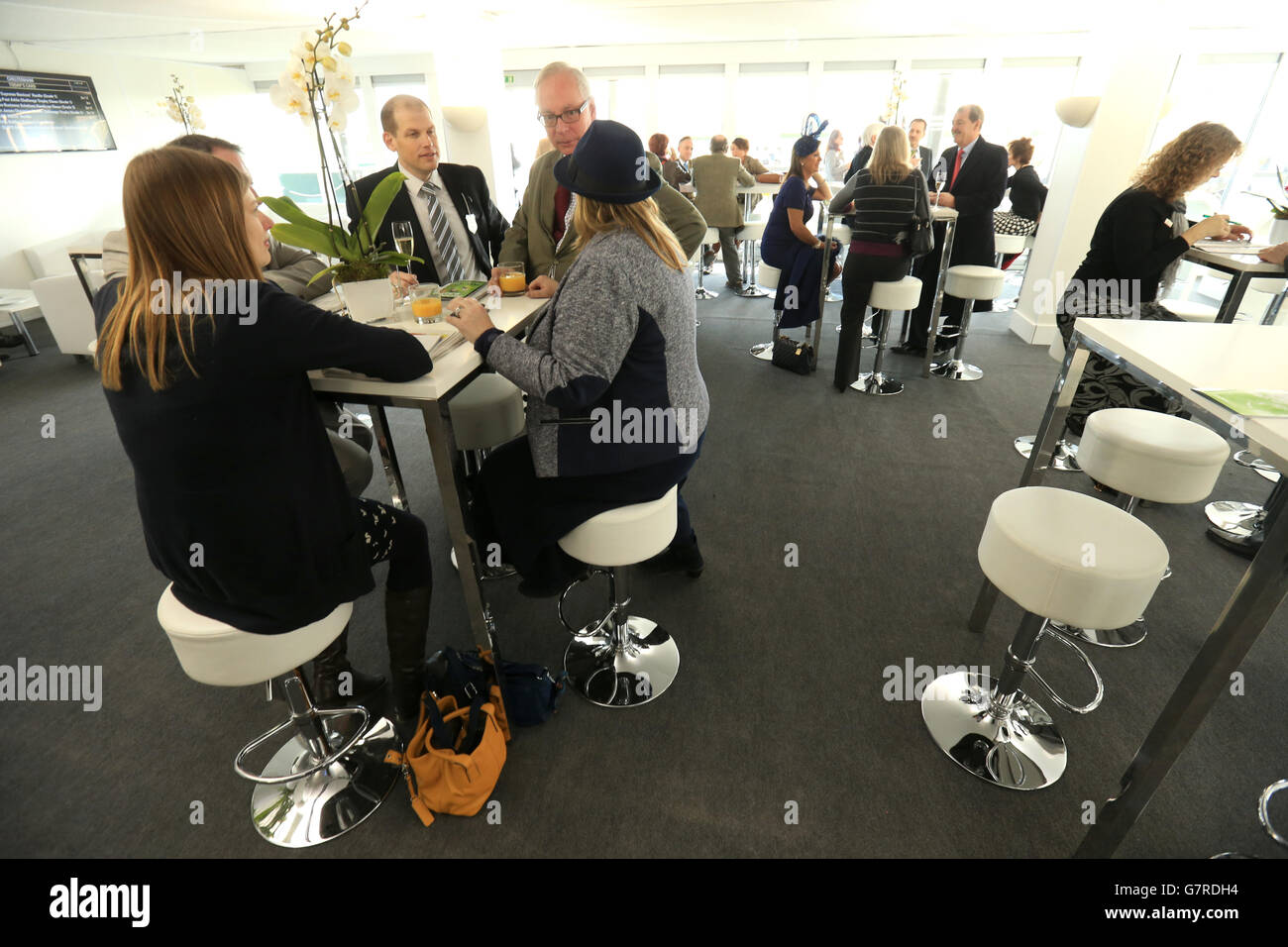 Racegoers enjoy the hospitality in the Club Room at Cheltenham Racecourse Stock Photo