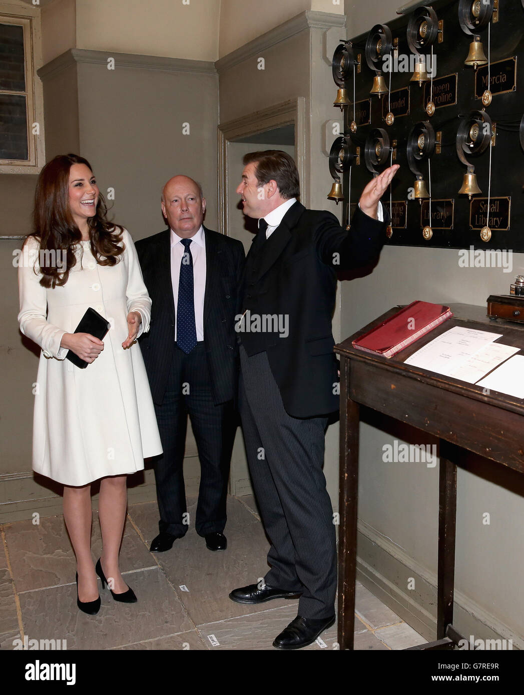 The Duchess of Cambridge is shown the Downton Abbey servants bells by actor Brendan Coyle (John Bates) and Lord Fellowes during an official visit to the set of Downton Abbey at Ealing Studios in London. Stock Photo