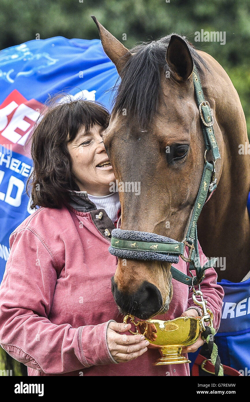 Cheltenham Gold Cup winner Coneygree eats from the trophy as he is led