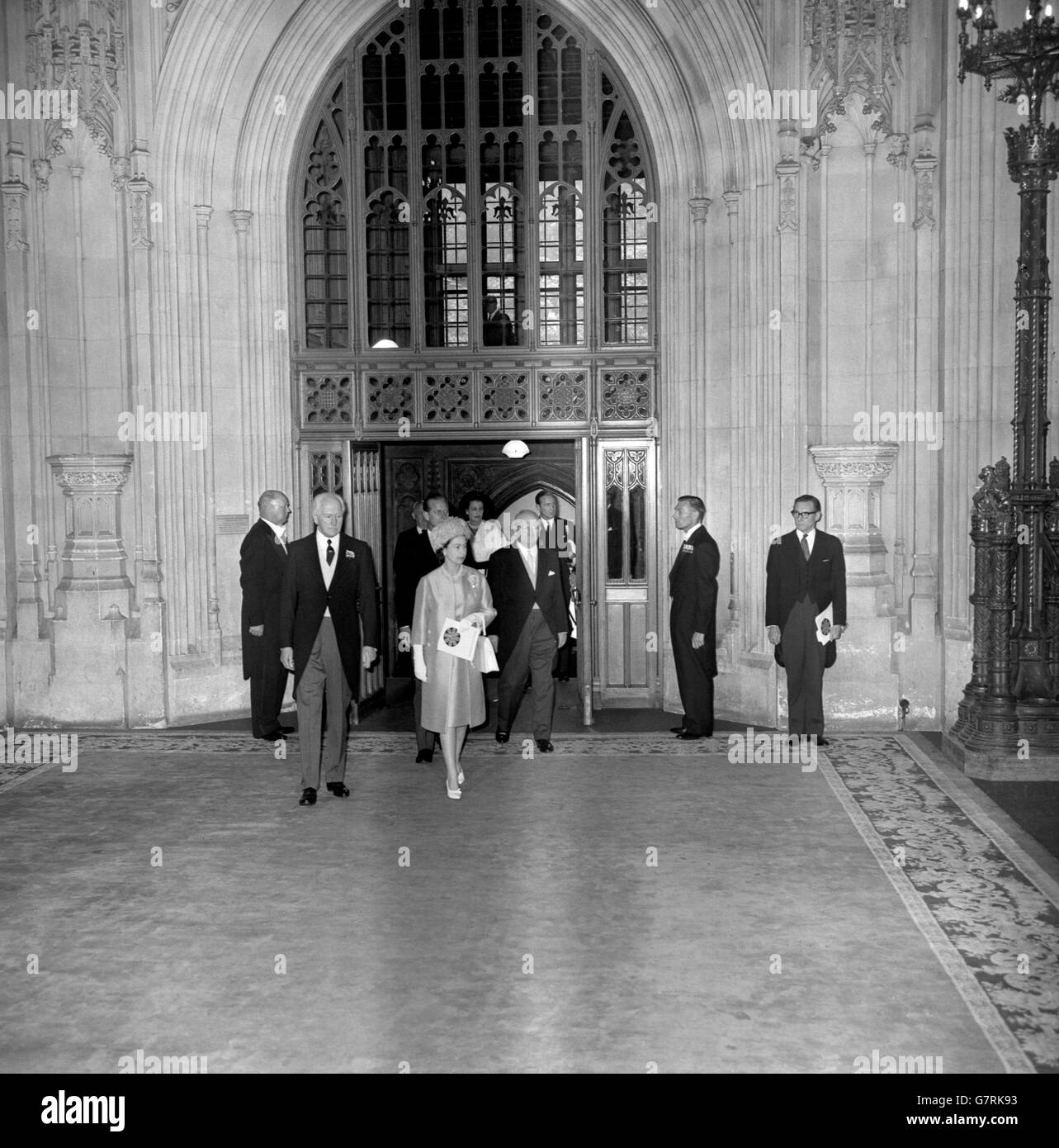 The Queen pictured with Lord Cholmondeley, the Lord Great Chamberlain (l), when she arrived at Westminster Hall, London, to attend a ceremony marking the 700th anniversary of Simon de Montfort's Parliament, the first to which representatives of the towns were summoned. The ceremony took the form of presentation of addresses to the Queen by both Houses of Parliament. Just behind the Queen is the Duke of Edinburgh. Stock Photo