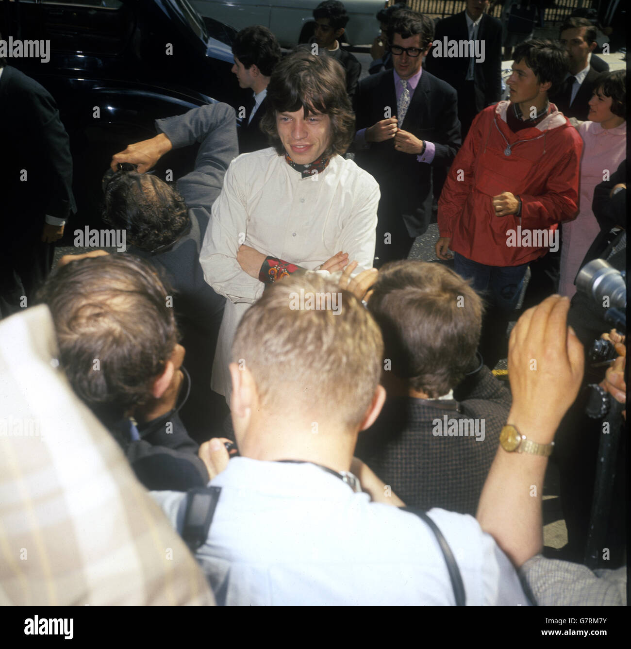 Mick Jagger, of the Rolling Stones, in purple satin trouser, offwhite