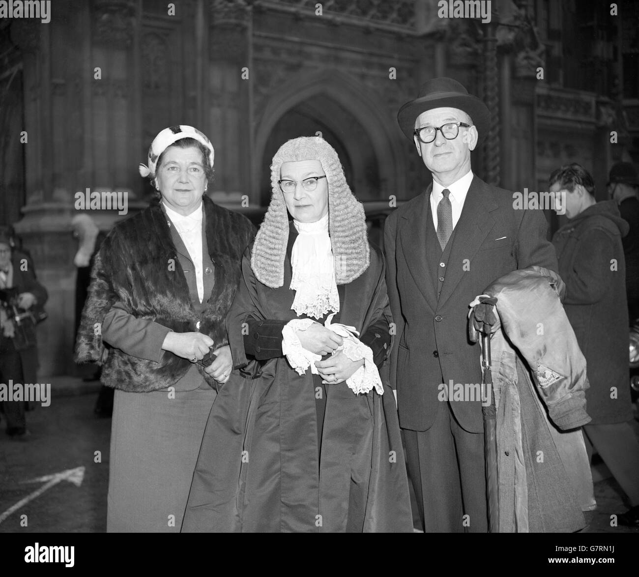 Elizabeth Kathleen Lane, QC, pictured after attending the swearing-in ceremony at the House of Lords in London. Mrs Lane is one of the best-known criminal court barristers in England. She was first called to the Bar in 1940 and is the wife to Henry Jerrold Randall Lane (r), the barrister. Mrs Lane was the first women to appear in a murder appeal at the House of Lords 14 years ago. She argued, unsuccessfully, for Leonard Holmes, an ex-soldier accused of murdering his wife. Also pictured is Mrs John Swallow (l). Stock Photo