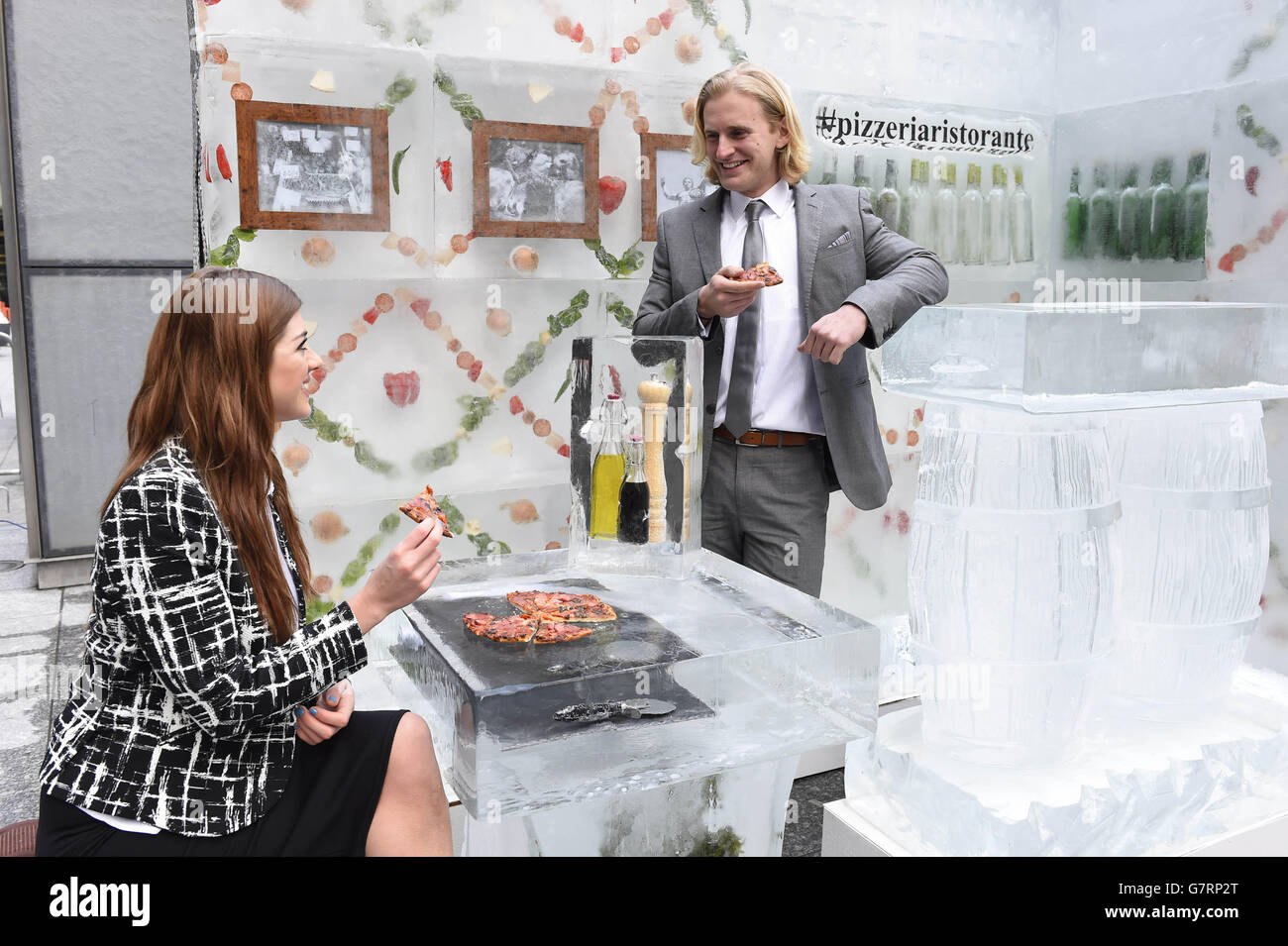 EDITORIAL USE ONLY Dan Dewhurst and Marie Louise Smith enjoy the Dr. Oetker Ristorante unique pizzeria, which is made out of four tonnes of ice, opens at Liverpool Street station in London, to showcase the freshness of frozen food. Stock Photo