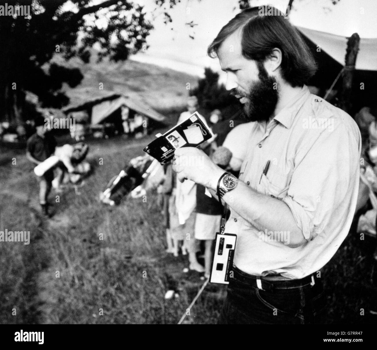 British Everest expedition leader Chris Bonington reads the instruction booklet as he test a new Kodak Pocket Instamatic 60 camera during the approach march to the base of the mountain from Katmandu. Four of the new cameras are being used by the climbers. Stock Photo