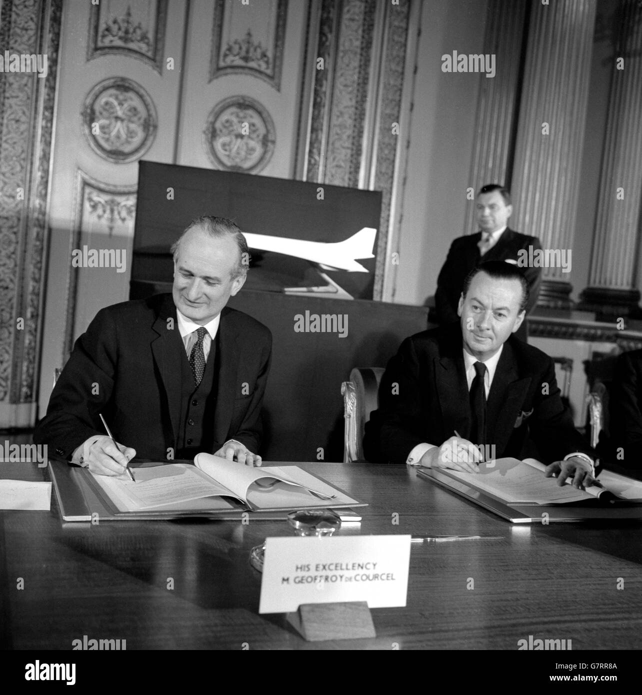 Julian Amery (r), Britain's Minister of Aviation, and Geoffroy Chodron de Courcel, French Ambassador, sign the agreement for the Anglo-French development of a supersonic jet airliner. The ceremony took place at Lancaster House, London. The new aircraft, designed to cruise at 1,450mph and to carry 100 passengers, will be built by the British Aircraft Corporation and Sud Aviation of France. It is expected to enter service in or about 1970. Stock Photo
