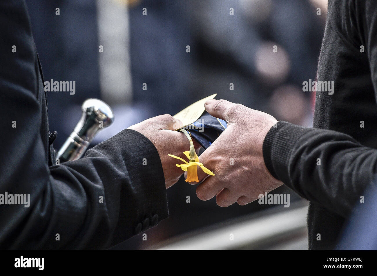 A daffodil and tie are handed over outside St Mary the Virgin Church, Barry, Wales, for the service of 17-year-old Corey Price, one of three teenagers killed in a car crash near Brecon earlier this month. Stock Photo