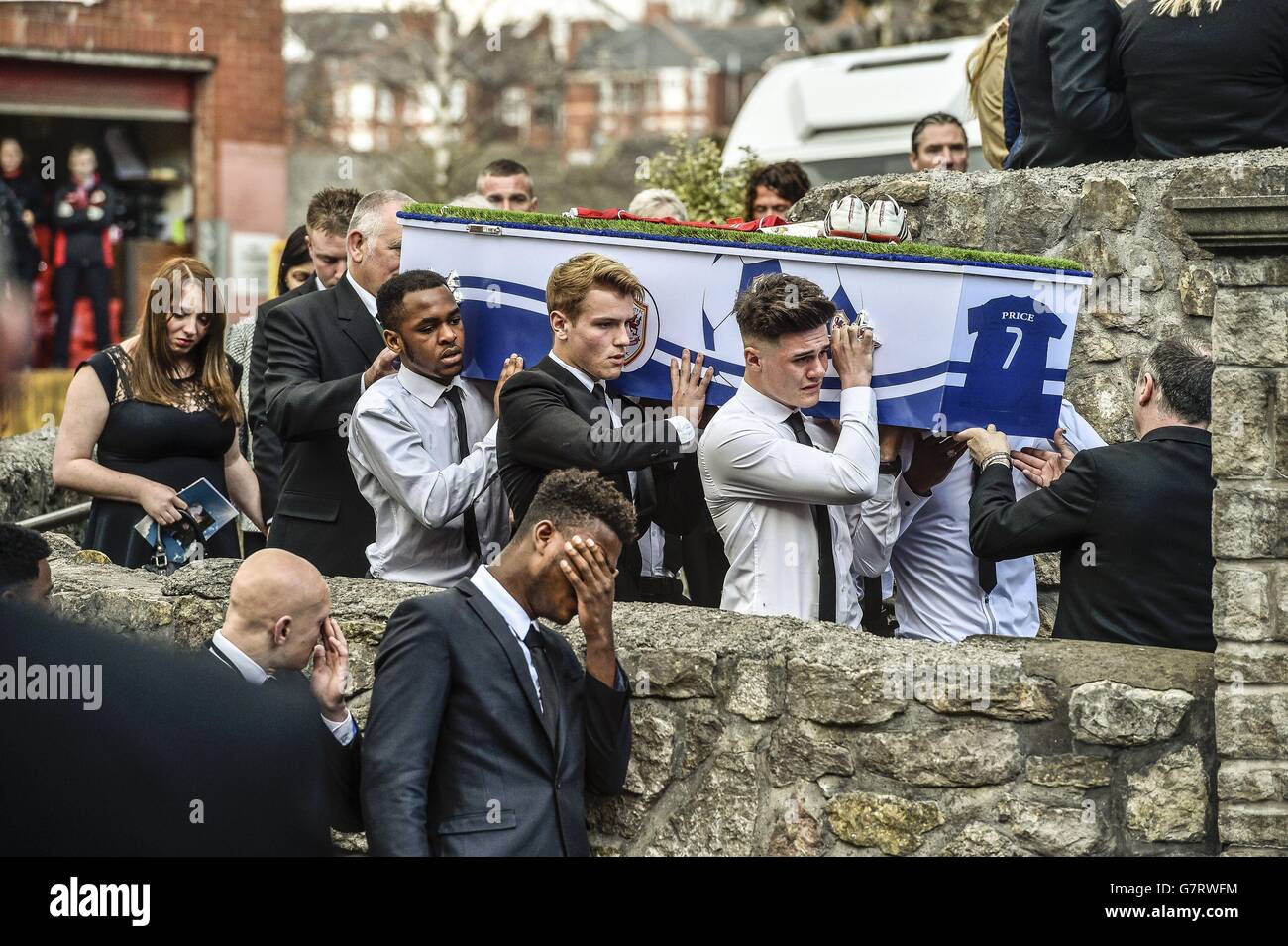 Pallbearers carry the grass-topped and football themed coffin of 17-year-old Corey Price, one of three teenagers killed in a car crash near Brecon earlier this month, arrives at St Mary the Virgin Church, Barry, Wales for his funeral. Stock Photo