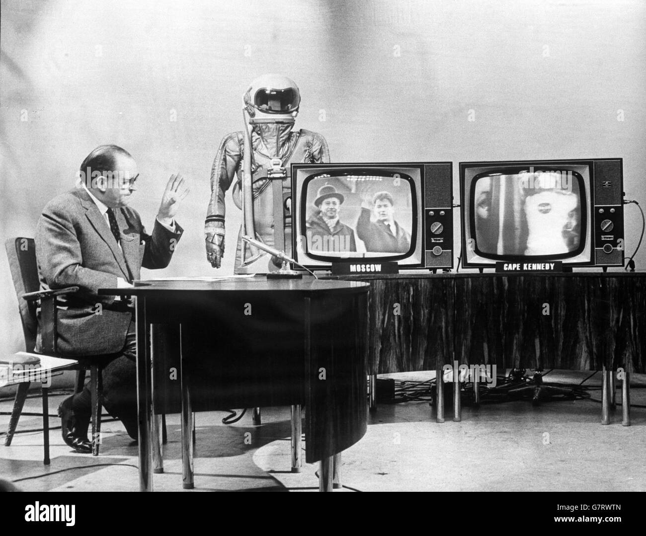 Richard Dimbleby is seen with monitor screens as live pictures from Moscow and Cape Kennedy were received simultaneously for the first time by BBC Television during a programme on Russia's latest space triumph and America's new attempt. The pictures from America were being received via space satellite and those from Russia through Eurovision link. Stock Photo