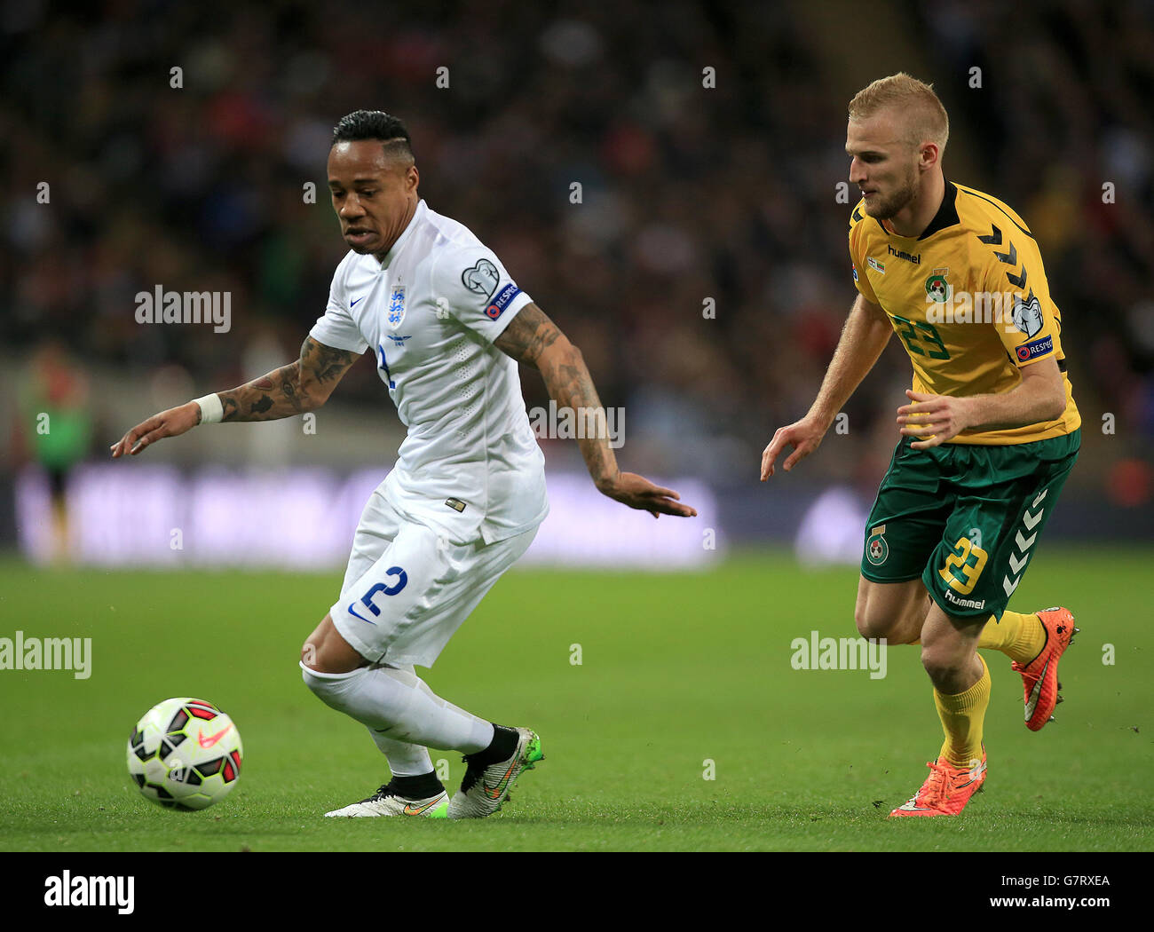 England's Nathaniel Clyne (left) and Lithuania's Vytautas Andriuskevicius battle for the ball during the UEFA 2016 Qualifying, Group E match at Wembley Stadium, London. Stock Photo