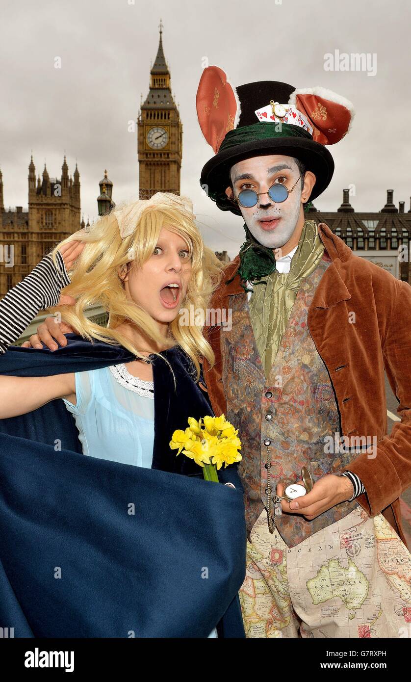 Laurane Marchive (left) as Alice and Oscar Richards as the White Rabbit from Alice in Wonderland in London as they celebrate 150 years of the tale and its connection to the seaside town of Llandudno. Stock Photo