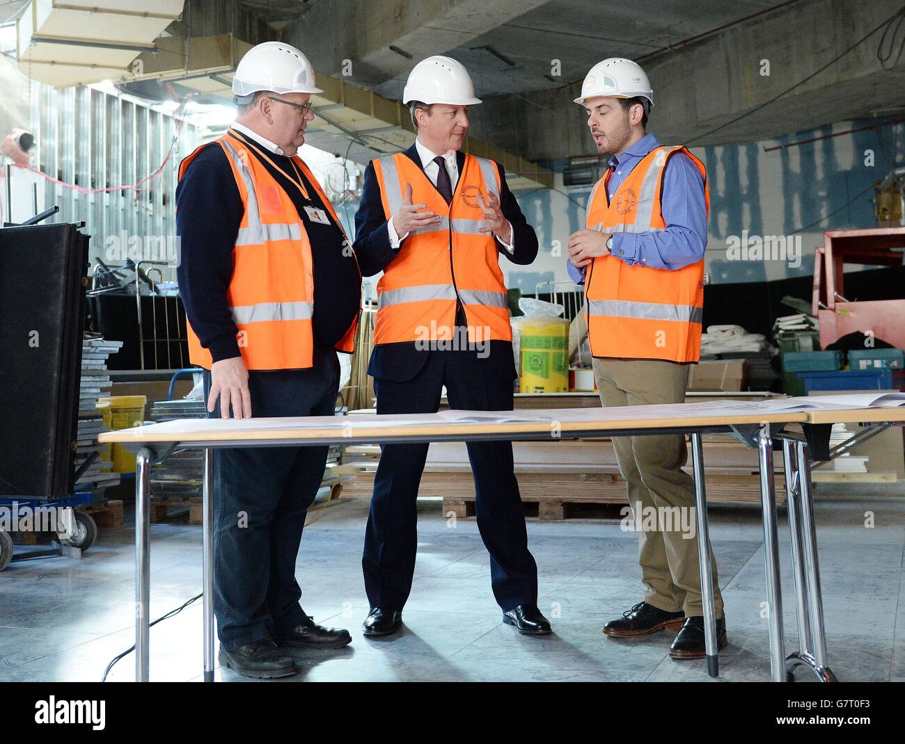Conservative party leader David Cameron (centre) views the new digital hub, under construction at the Sainsbury's head office in Holborn London, during the 2015 election campaign. Stock Photo