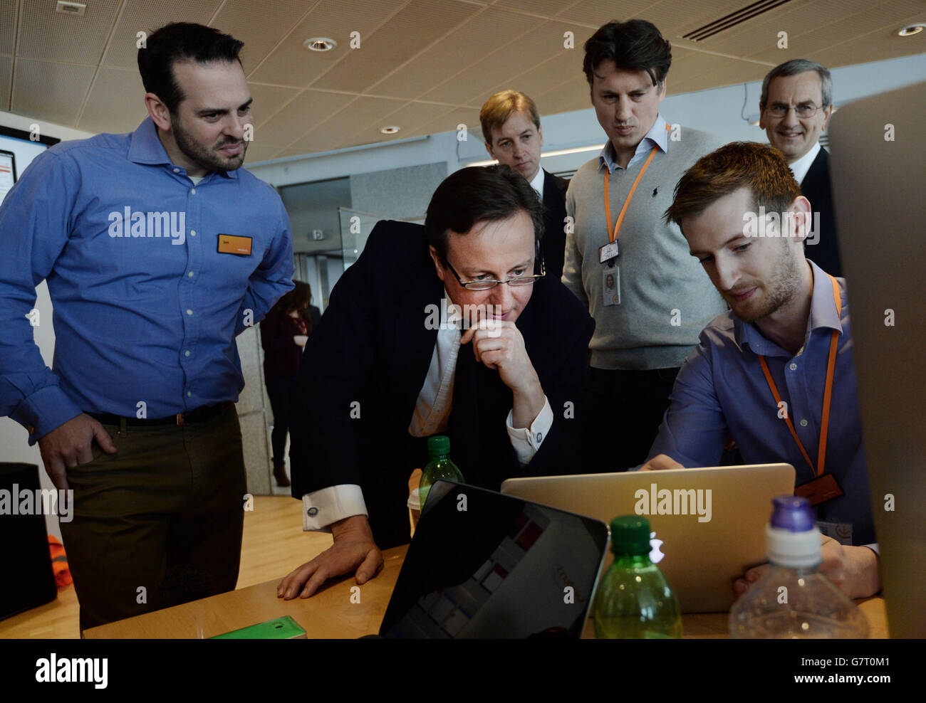 Conservative party leader David Cameron (centre) talks with Sainsbury's web and online designers at the Sainsbury's head office in Holborn London, during the 2015 election campaign. Stock Photo