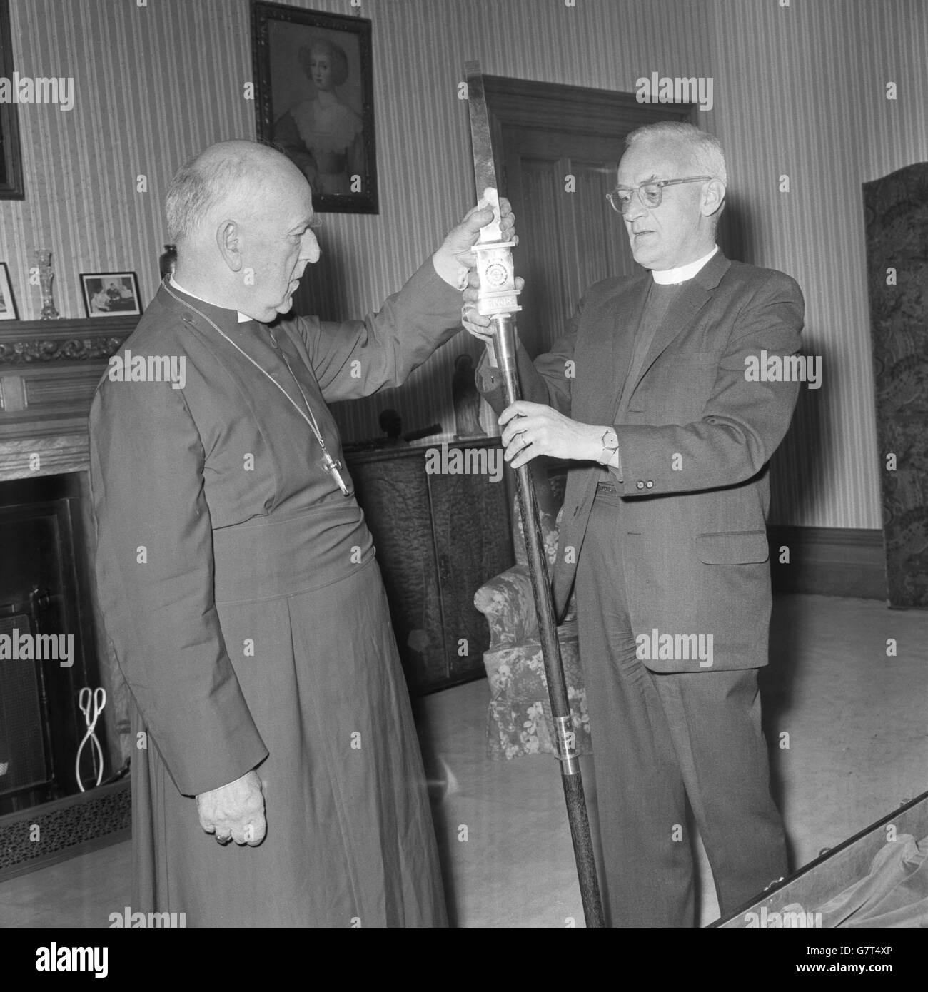 Anglican Executive Officer, Bishop Stephen F. Bayne (r) presents at Lambeth Palace, London, a fine silver crosier to the Archbishop of Canterbury, Dr. Geoffrey Fisher, as a gift, on the occasion of his approaching retirement, from the 33 bishops and archbishops who are his fellow Metropolitans of the Anglican Communion. The crosier, or shepherd's staff, is the characteristic emblem of a bishop's office, borne by him in procession or as he takes part in the worship and life of the church. Stock Photo