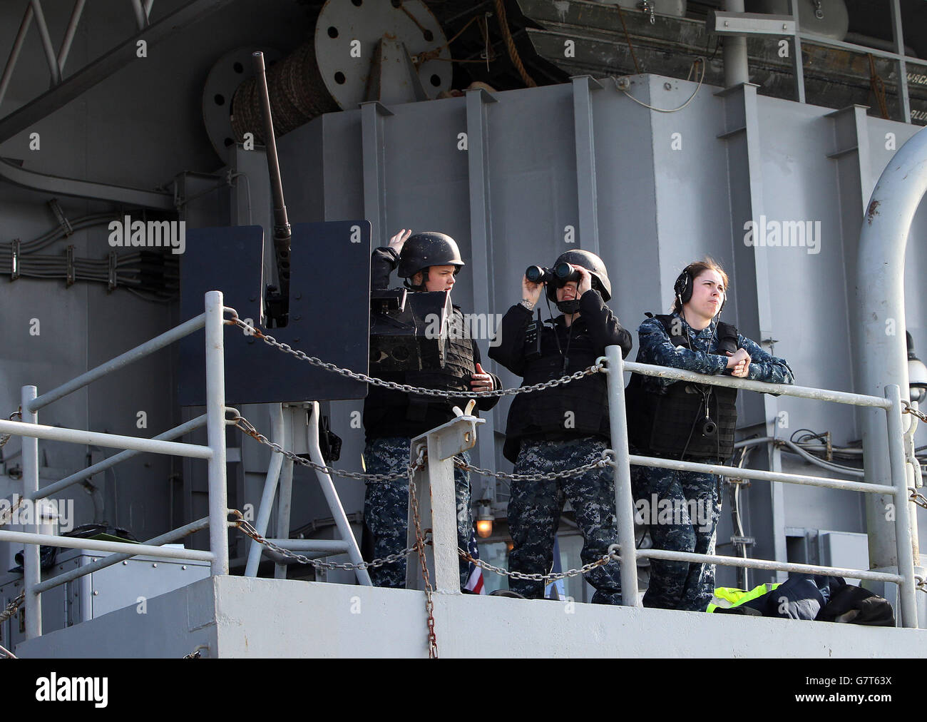 US naval personnel onboard the US aircraft carrier USS Theodore Roosevelt, currently at anchor off the UK's south coast as it is too big to enter one of the Royal Navy's major bases, the carrier, one of ten Nimitz class aircraft carriers in the US fleet, arrived at Portsmouth, Hampshire, yesterday for a five-day visit. Stock Photo