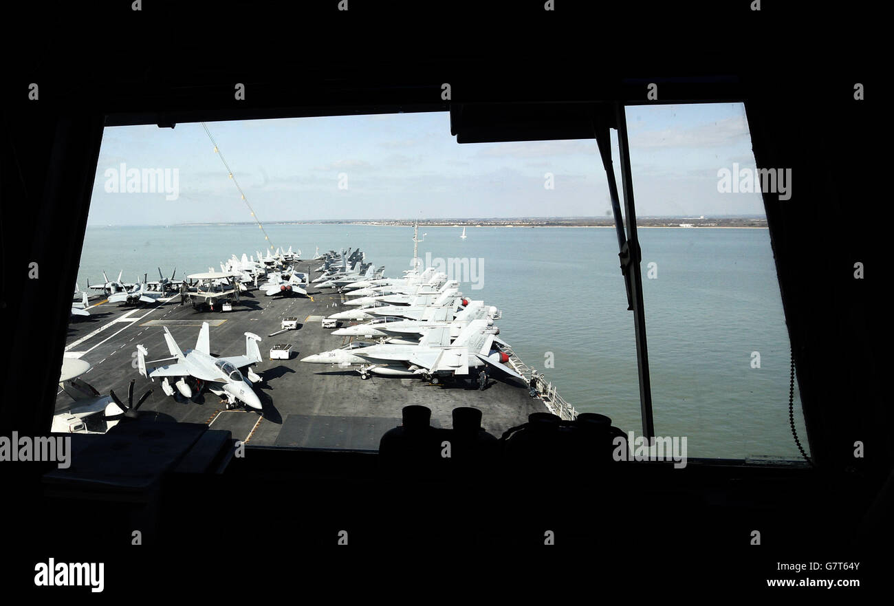 Planes parked on the flight deck of the US aircraft carrier USS Theodore Roosevelt, currently at anchor off the UK's south coast as it is too big to enter one of the Royal Navy's major bases, the carrier, one of ten Nimitz class aircraft carriers in the US fleet, arrived at Portsmouth, Hampshire, yesterday for a five-day visit. Stock Photo