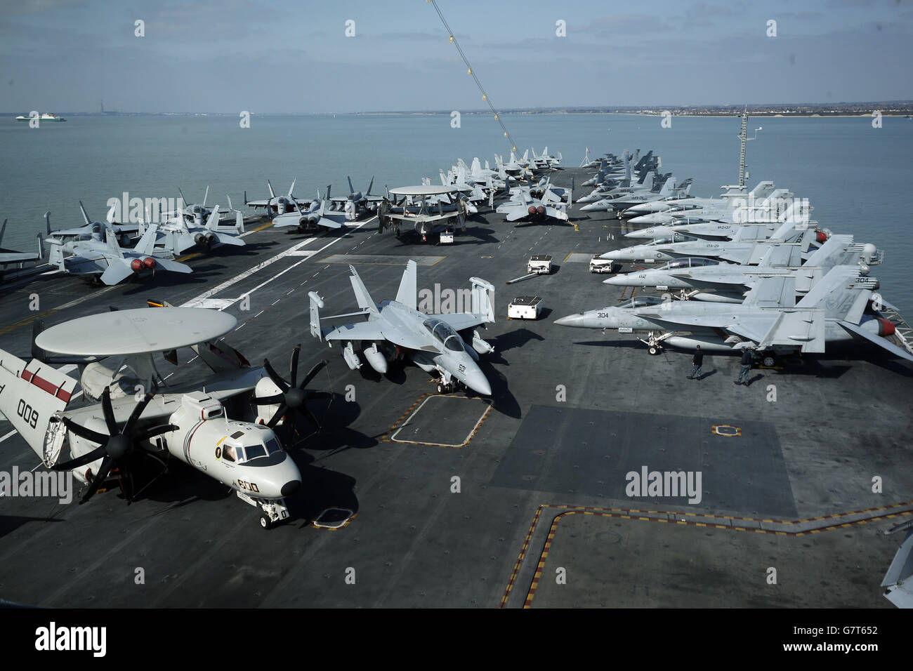 Planes parked on the flight deck of the US aircraft carrier USS Theodore Roosevelt, currently at anchor off the UK's south coast as it is too big to enter one of the Royal Navy's major bases, the carrier, one of ten Nimitz class aircraft carriers in the US fleet, arrived at Portsmouth, Hampshire, yesterday for a five-day visit. Stock Photo