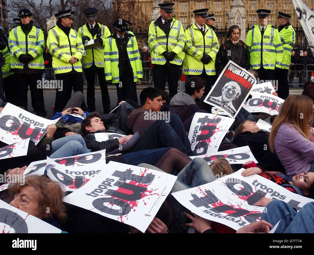 Dozens of anti-war protesters taking part in a mass 'die-in' outside Parliament. The protestors are calling for British troops to be withdrawn from Iraq. Chanting slogans and holding banners, the activists blocked two lanes of the road during the event organised by the Stop The War Coalition and CND. Stock Photo