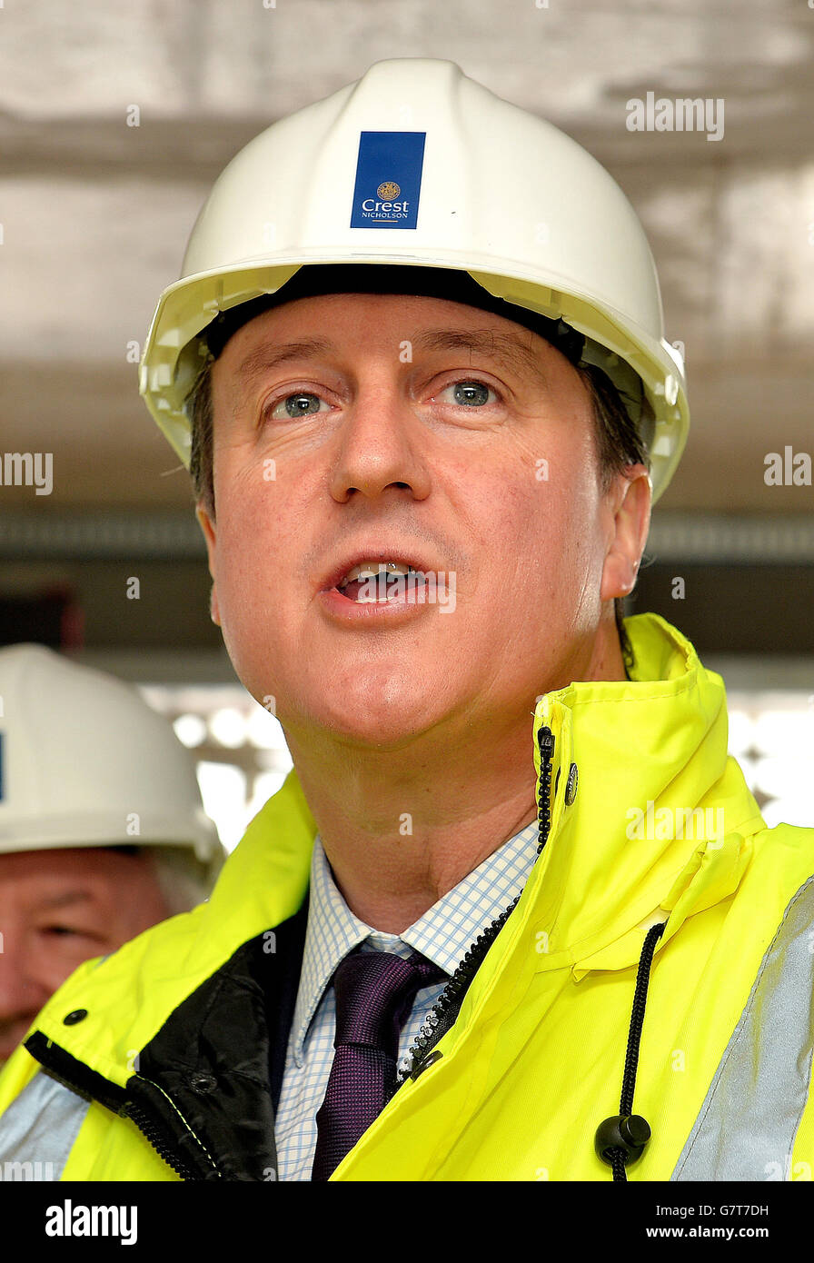 Prime Minister David Cameron wearing a hard hat and high visibility jacket, during a visit to a building site where they are constructing private flats in Isleworth, west London. Stock Photo