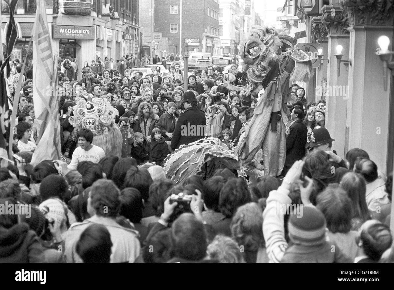 A traditional dragon rears over the crowd in Gerrard Street, Soho, as London welcomes in the Chinese Year of the Monkey. Stock Photo