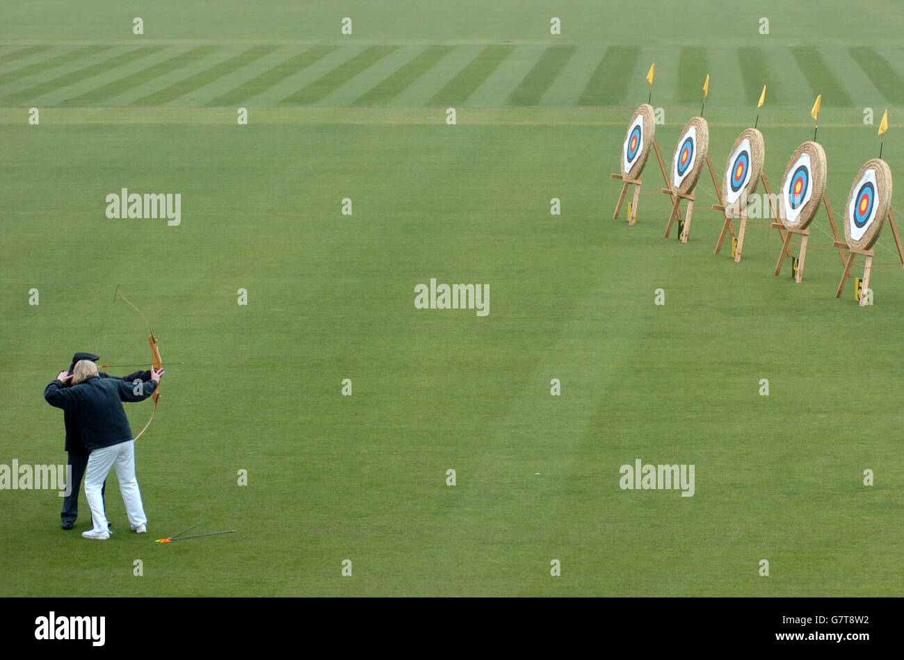 South African Sam Ramsamy is shown by an archer how to fire an arrow at Lords Cricket Ground