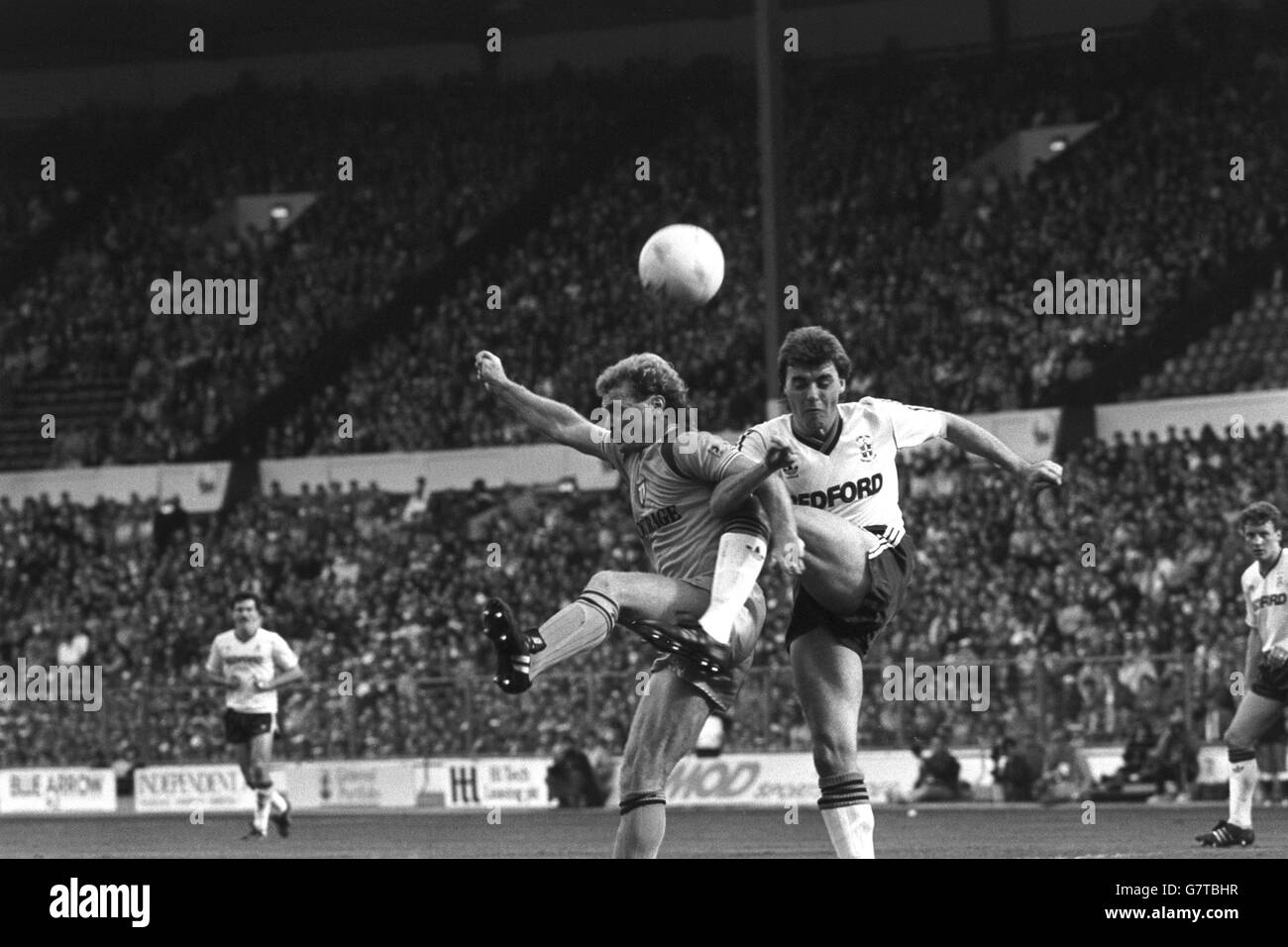 Reading midfielder Les Taylor (l) and Luton Town defender Mal Donaghy link arms while contending for the ball during a Reading attack at Wembley in the Full Members Cup Final. Reading won 4-1. Stock Photo