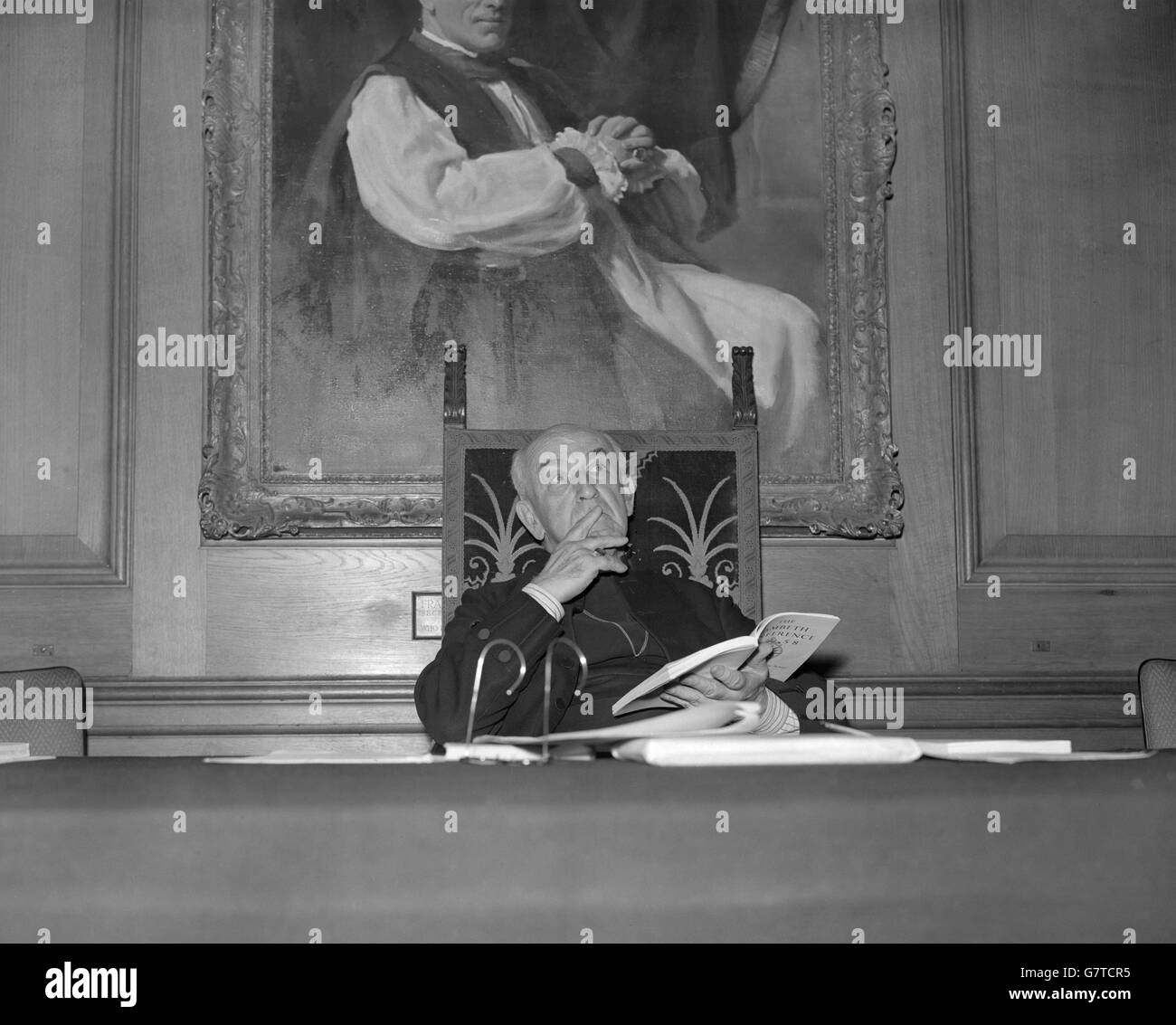 Thoughtful moment for the Archbishop of Canterbury, Dr. Geoffrey Fisher, as he ponders a point in the report of the 1958 Lambeth Conference at a press conference he was holding at Church House, Westminster, London. Stock Photo