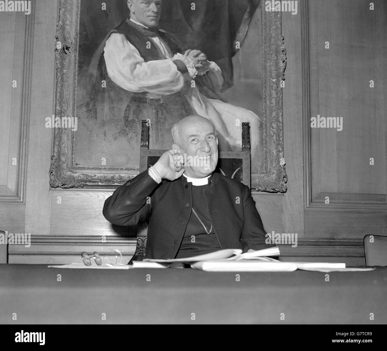A humorous moment for the Archbishop of Canterbury, Dr. Geoffrey Fisher, as he ponders a point in the report of the 1958 Lambeth Conference at a press conference he was holding at Church House, Westminster, London. Stock Photo