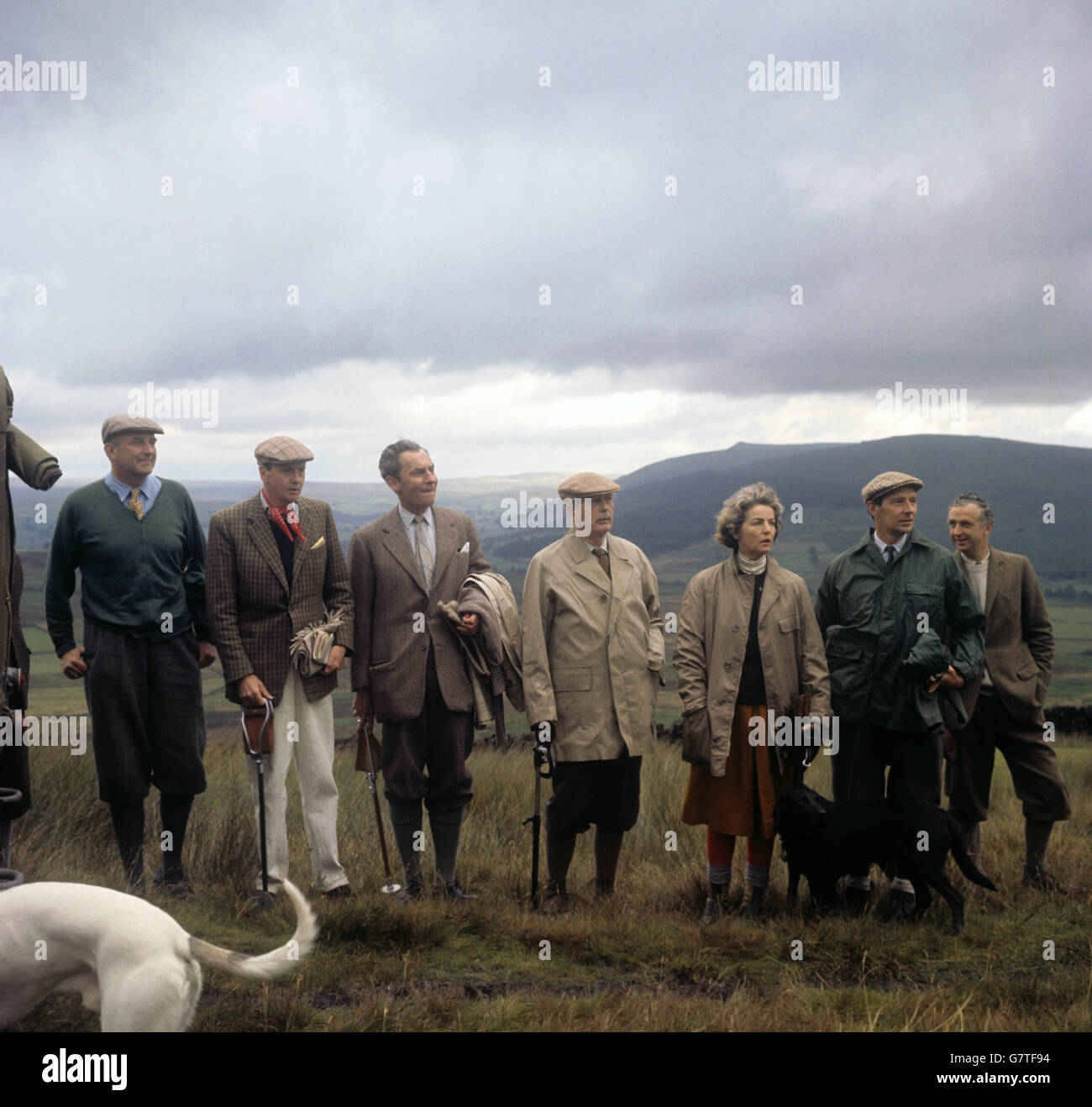Mr. Harold Macmillan (c) is pictured with other members of the party during the first days grouse shooting, near Bolton Abbey. Left to right: unknown, The Duke Of Devonshire; the Prime minister's nephew; Mr. Hugh Fraser, Secretary of State for Air; The Prime Minister; the Duchess of Devonshire, and Sir David Ormsby-Gore. Stock Photo
