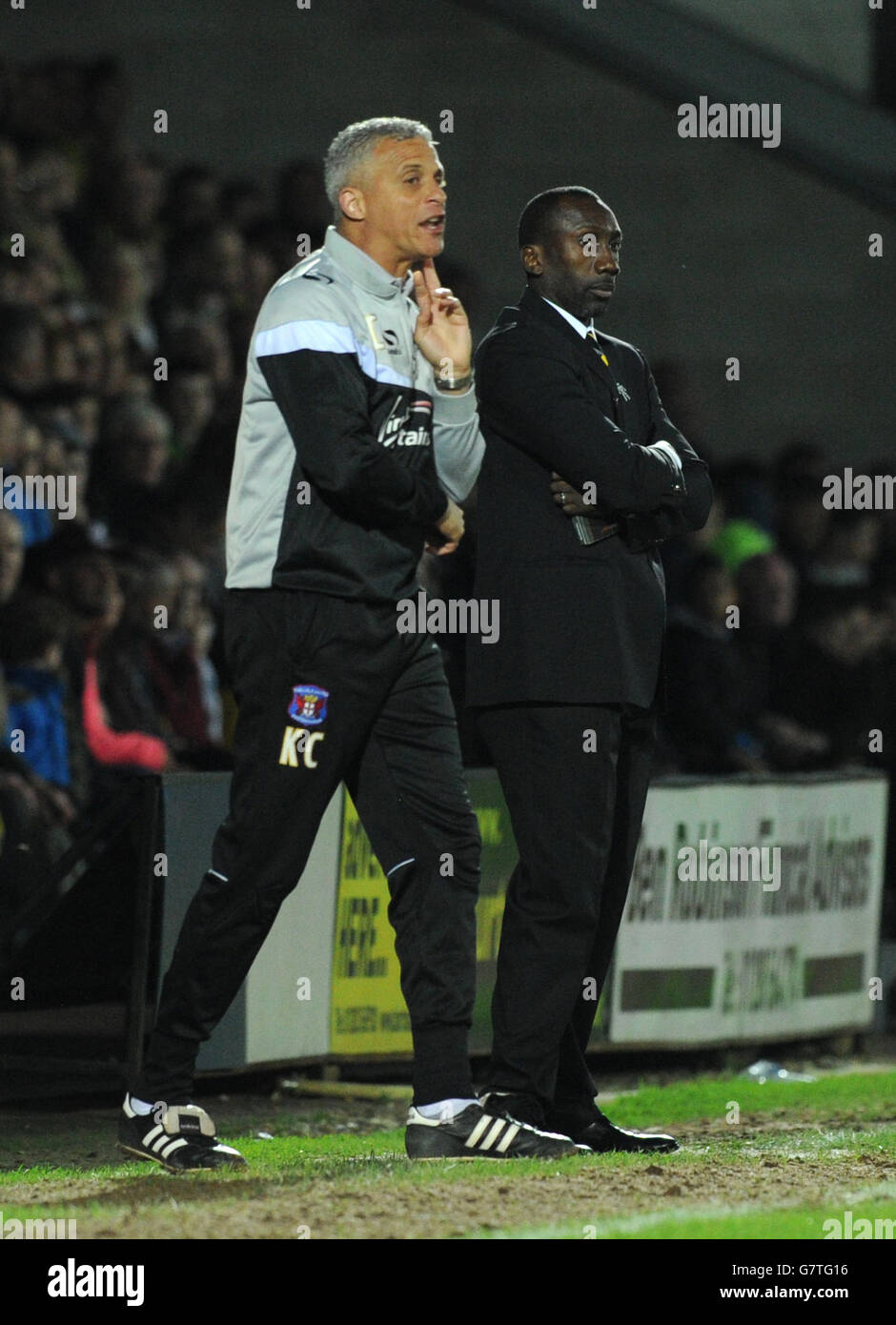 Burton Albion manager Jimmy Floyd Hasselbainnk and Carlisle manager Keith Curle (left) on the touchline during the Sky Bet League Two match at the Pirelli Stadium, Burton. Stock Photo