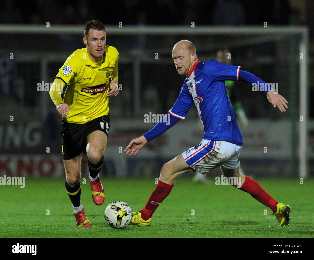 Carlisle's Jason Kennedy (right) and Burton Albion's Tom Naylor battle for the ball during the Sky Bet League Two match at the Pirelli Stadium, Burton. Stock Photo