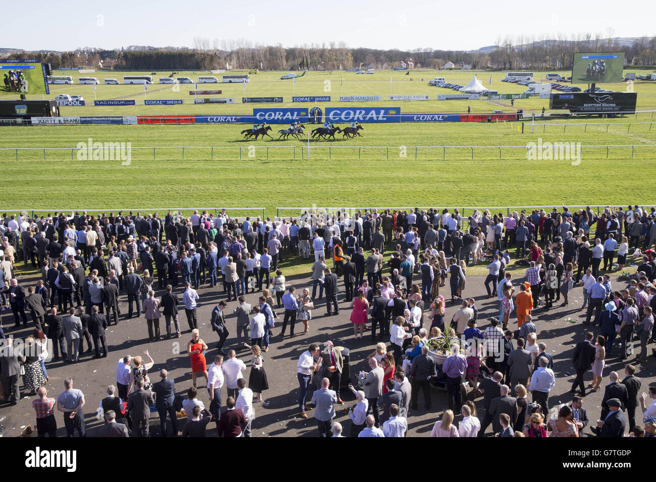 Runners and riders during the Dawn Homes Ayrshire Hands and Heels Finale Handicap Hurdle during the 2015 Coral Scottish Grand National Festival at Ayr Racecourse. Stock Photo