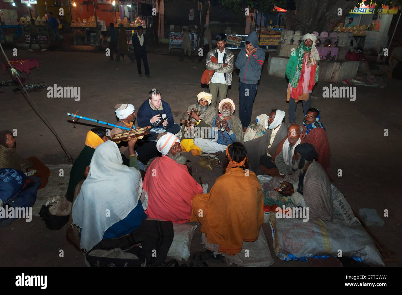 Group of Sadhus plays in local musical instruments in the central square at night. Orchha. Stock Photo