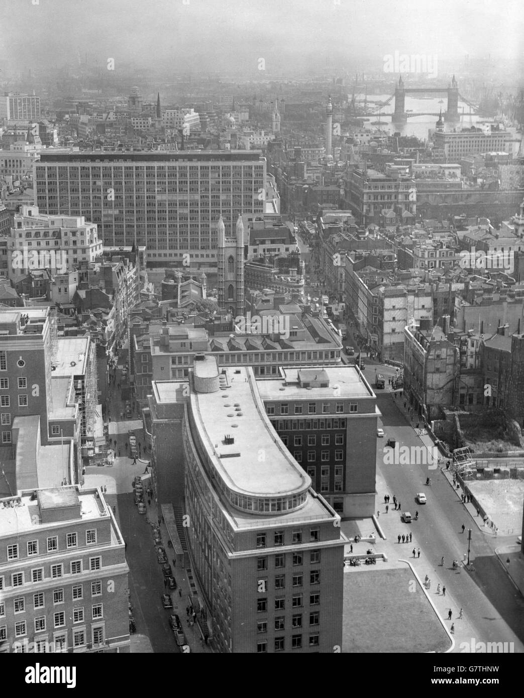 View of the new Bank of England extension building in New Change, London. The massive new building is built on the a 2 and half acre site which formerly housed offices and shops but was badly damaged in the Blitz. This image was taken from the dome of St. Paul's Cathedral. Tower Bridge can been see in the far distance. Stock Photo