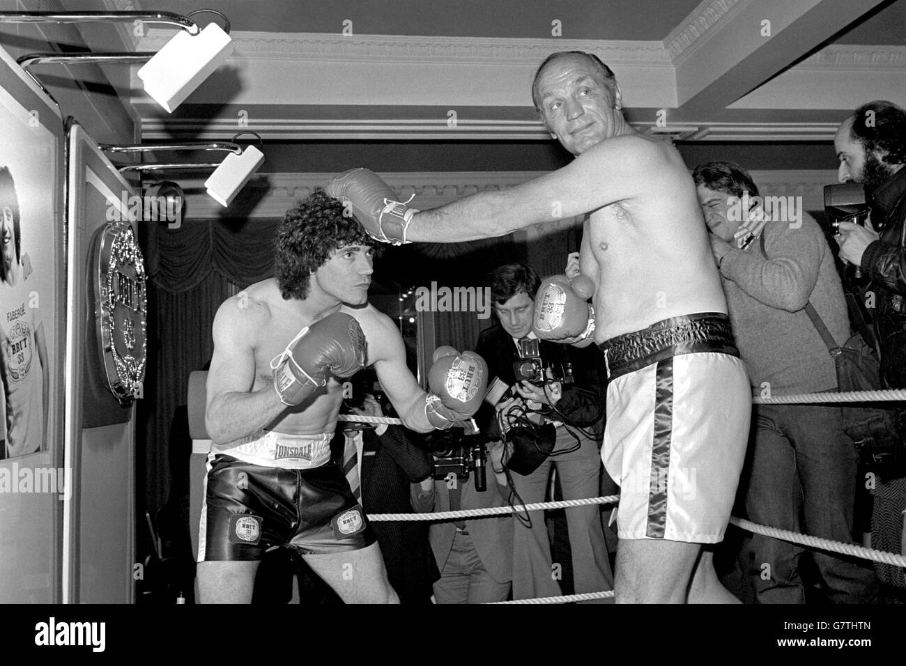 Kevin Keegan and Henry Cooper Advertise Brut 33. Kevin Keegan (l) and Henry Cooper (r) fool around in a miniature boxing ring to promote Brut 33 aftershave Stock Photo