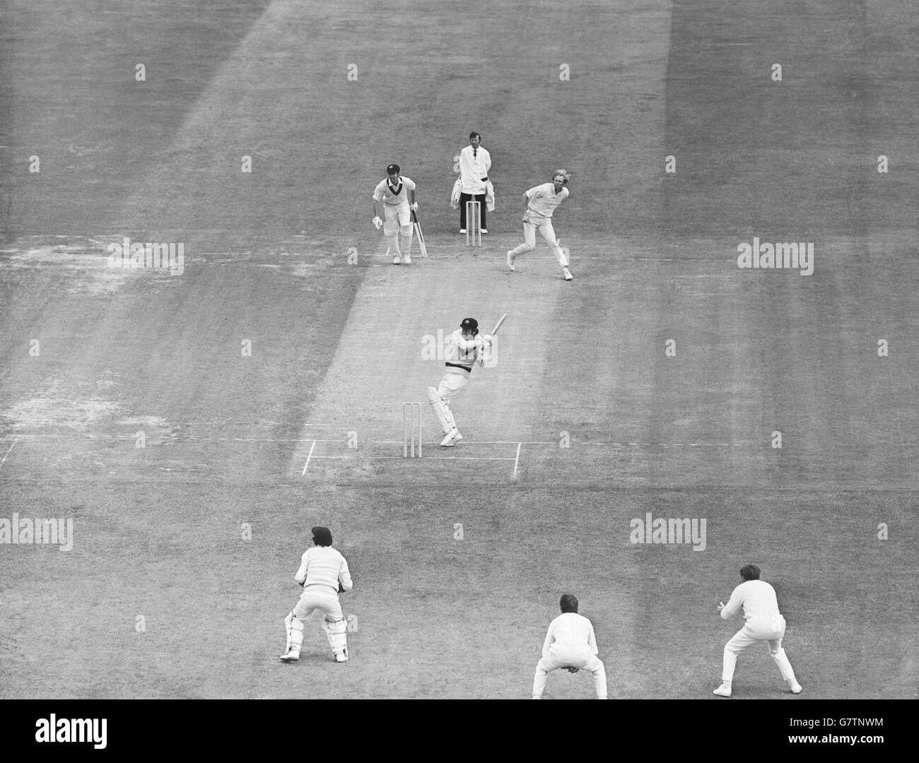 Australia's Ian Chappell (c) hooks a ball from England's Tony Greig (top r) to the boundary for four runs, watched by teammate Greg Chappell (top l) Stock Photo